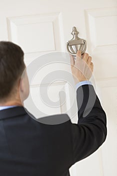 Businessman Knocking Door Handle photo