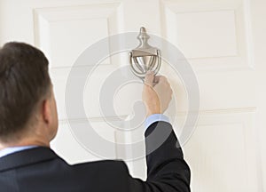 Businessman Knocking Door Knocker