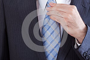 Businessman knotting his tie