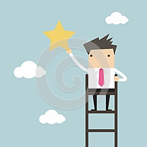 Businessman on a ladder grab star in the sky