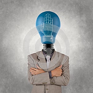 Businessman with lamp-head and hand rised sign photo