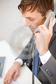Businessman with laptop computer and phone