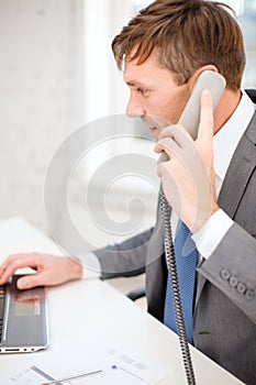 Businessman with laptop computer and phone
