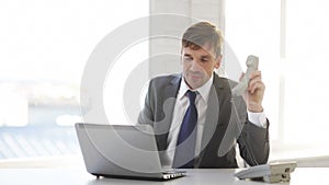 Businessman with laptop computer and phone