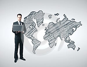 Businessman with laptop and drawing world map