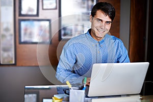 Businessman, laptop and portrait in workplace professional, salesman and working in office. Male person, smile and happy