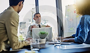 Businessman, laptop and presentation with team in discussion, meeting or development at office. Man or coach talking to