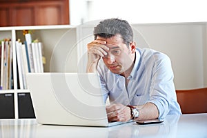 Businessman, laptop and stress or anxiety at office, email and online research on technology. Mature man, frustrated and