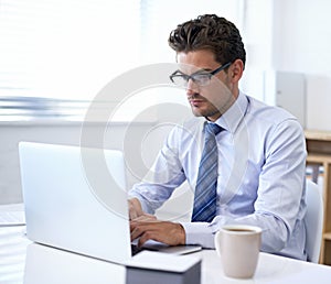 Businessman, laptop and typing in office for online communication as financial consultant, email or internet. Male