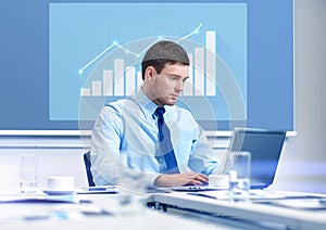 Businessman with laptop working in office