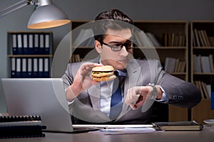 The businessman late at night eating a burger photo