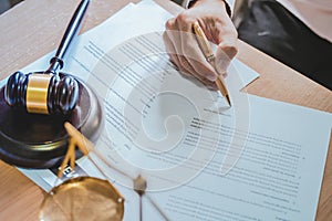 Businessman or lawyers sitting office signing contract papers on wood table.