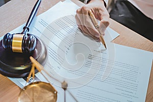 Businessman or lawyers sitting office signing contract papers on wood table. photo