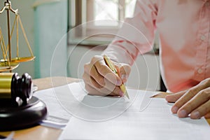 businessman or lawyers sitting office signing contract papers on wood table. Law of advisor Concepts and vintage, Sunset light.