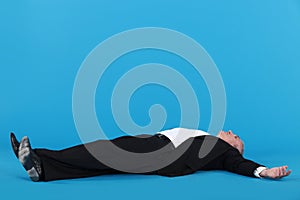 Businessman laying on floor