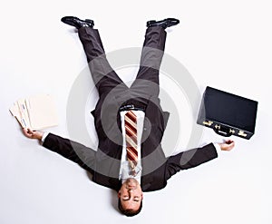 Businessman laying on floor and briefcase