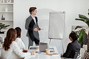 Businessman leader giving presentation on mockup empty whiteboard to business team in conference room