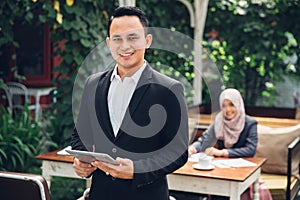 Businessman leader standing in front of his team