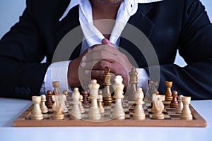 Businessman leadership hand moving of playing chess   concept: symbol confident new strategy plan for win and success,  sports gam