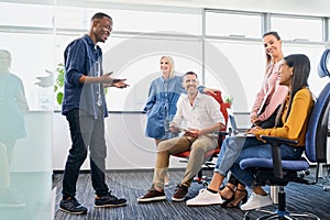 Businessman leading meeting with work colleagues in startup office