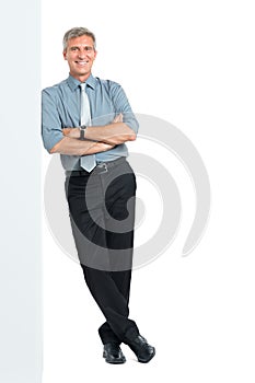 Businessman Leaning Against Sign