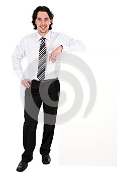 Businessman leaning on a billboard