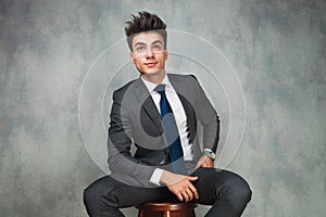 Businessman leaning his elbow against wall and looks away