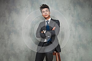 Businessman leaning his elbow against wall and looks away