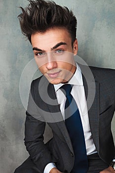 Businessman leaning his elbow against wall and looks away
