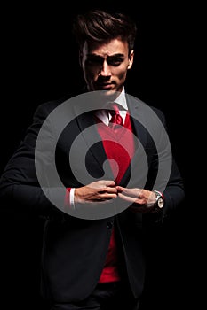 Businessman leaning his elbow against wall and looks away