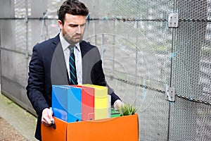 Businessman leaving his office after bank bankruptcy