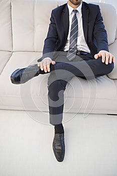 Businessman with leg on his knee