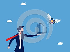 Businessman let the target fly out of the cage. liberation and freedom in goals