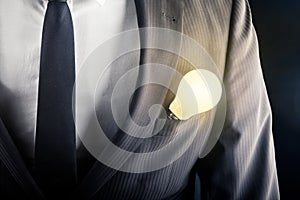 Businessman with light bulb on front pocket