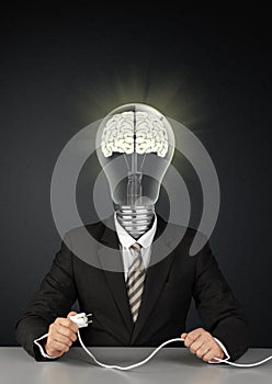 Businessman with light bulb head and plug, switch brain creative