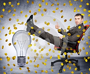 Businessman with light bulb under coin rain