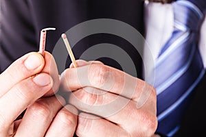 Businessman lighting a tiny firecracker