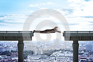 Businessman linking broken bridge