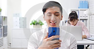 Businessman look at phone happily