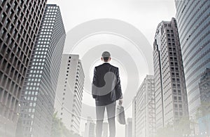 Businessman looking across the city financial district concept for entrepreneur, leadership and success