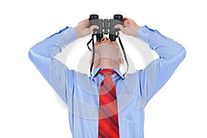 Businessman looking through binoculars