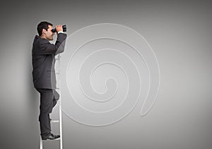 Businessman looking through binoculars while standing on the ladder