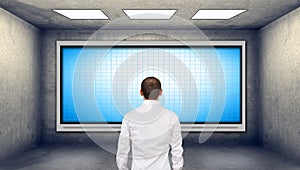 Businessman looking at blank plasma tv