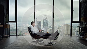 Businessman looking at business papers in office. Employee sitting in chair