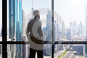 Businessman Looking At Cityscape Through Window