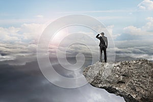 businessman looking on cliff with natural sky daylight cloudscape