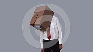 Businessman looking down with box on head