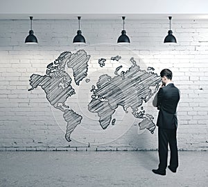 Businessman looking on drawing world map