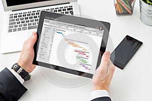 Businessman looking at Gantt chart on tablet computer