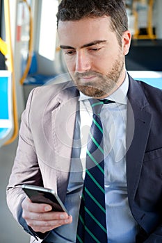 Businessman is looking at his mobile phone